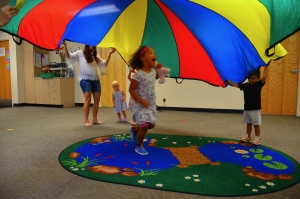 Class with parachute, girl running unter